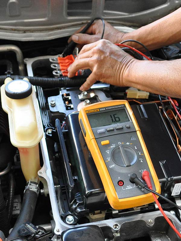 image of Masaki Auto worker repairing hybrid car battery